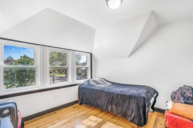 a bedroom with bed and balcony