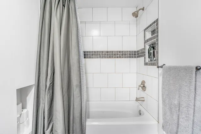 a bathroom with a bathtub and a shower