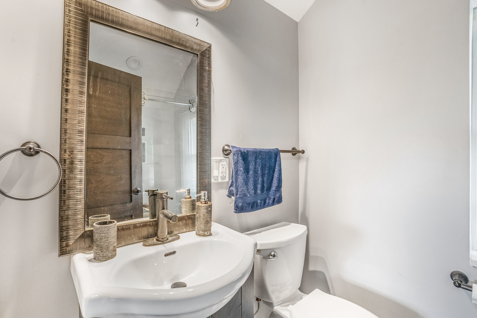 4158 West 58th Place, Unit 4158 Chicago, IL 60629 - Photo 16 of 22 a bathroom with a toilet a sink and mirror