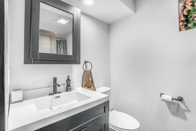a bathroom with a sink toilet and mirror