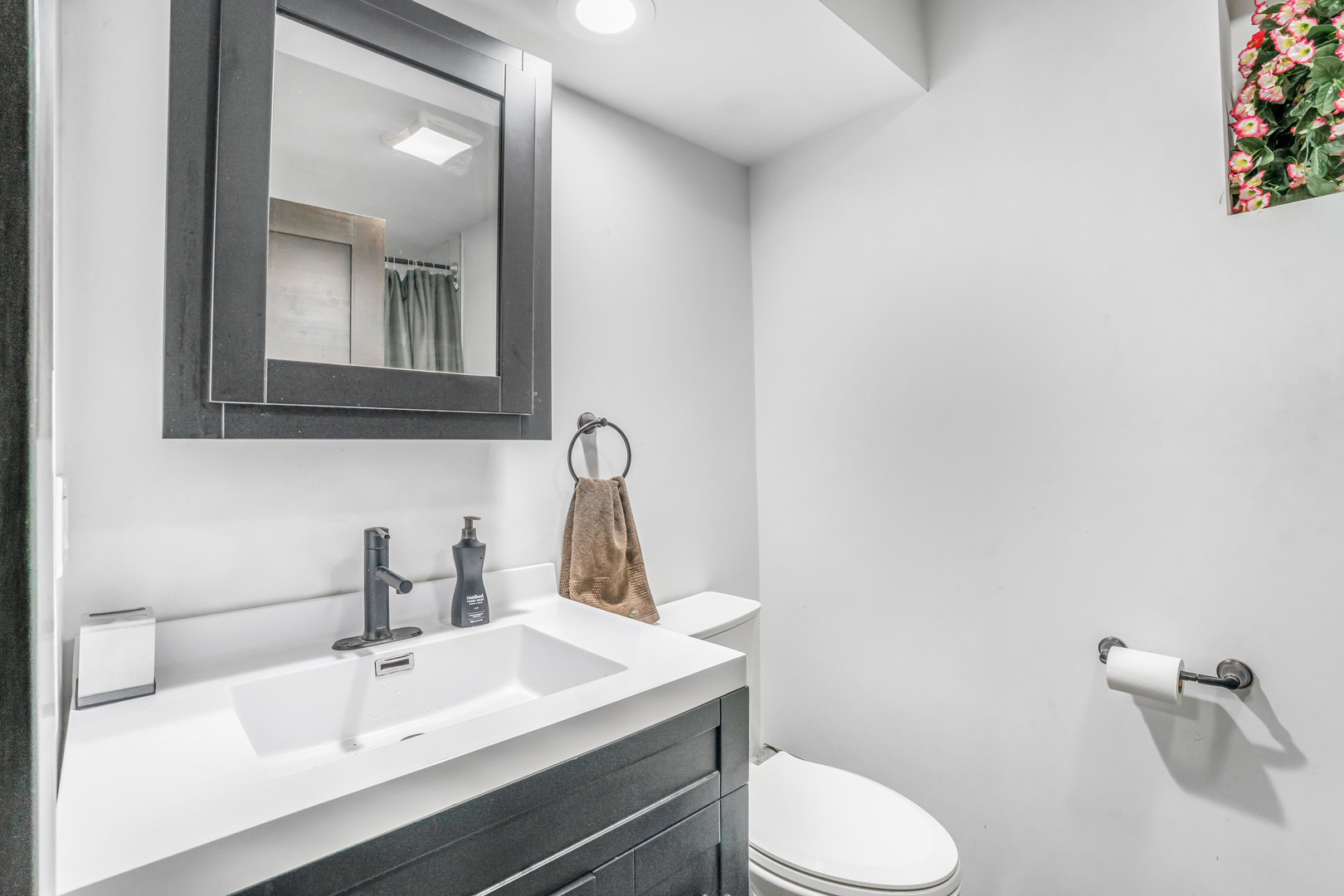 4158 West 58th Place, Unit 4158 Chicago, IL 60629 - Photo 19 of 22 a bathroom with a sink toilet and mirror