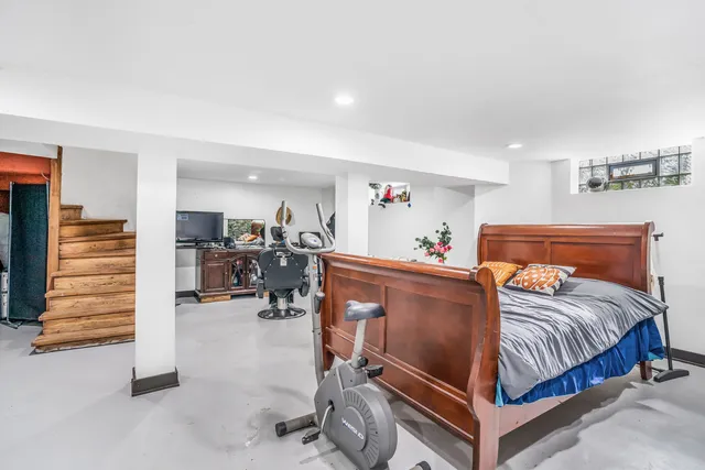 a bedroom with furniture and a wooden floor