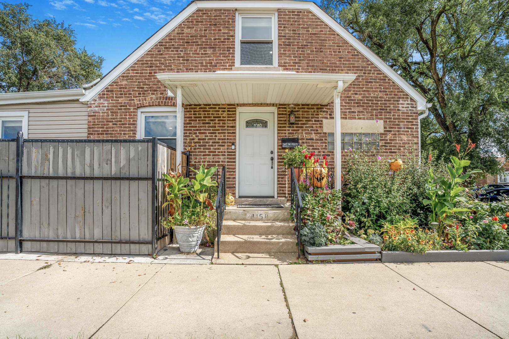 4158 West 58th Place, Unit 4158 Chicago, IL 60629 - Photo 2 of 22 a front view of a house with garden
