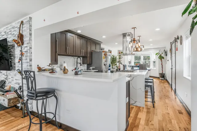 a kitchen with kitchen island granite countertop wooden cabinets and stainless steel appliances