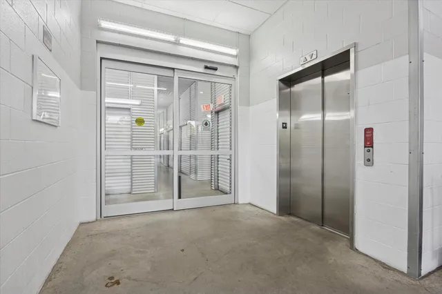 a living room with furniture and large windows