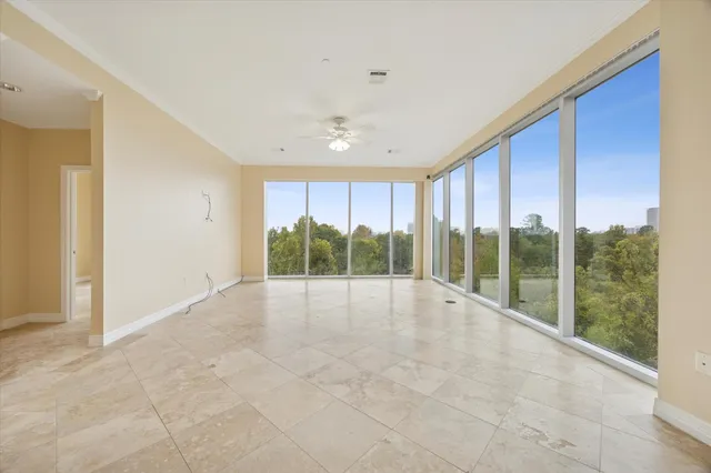 a view of an empty room with windows and yard