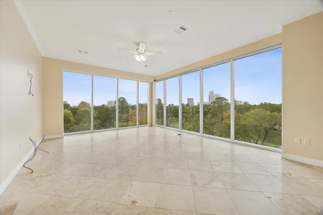 a view of an empty room with windows and balcony