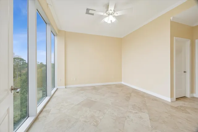 a view of an empty room with a ceiling fan