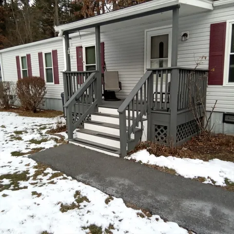 a view of a house with a snow in the yard