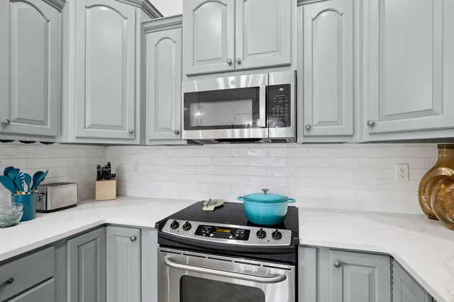 a bedroom with a bed a chandelier and a couch