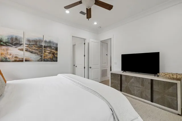 a bedroom with a large bed and a chandelier