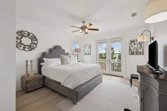 a bedroom with furniture and large windows
