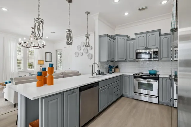 a kitchen with stainless steel appliances a sink stove and refrigerator