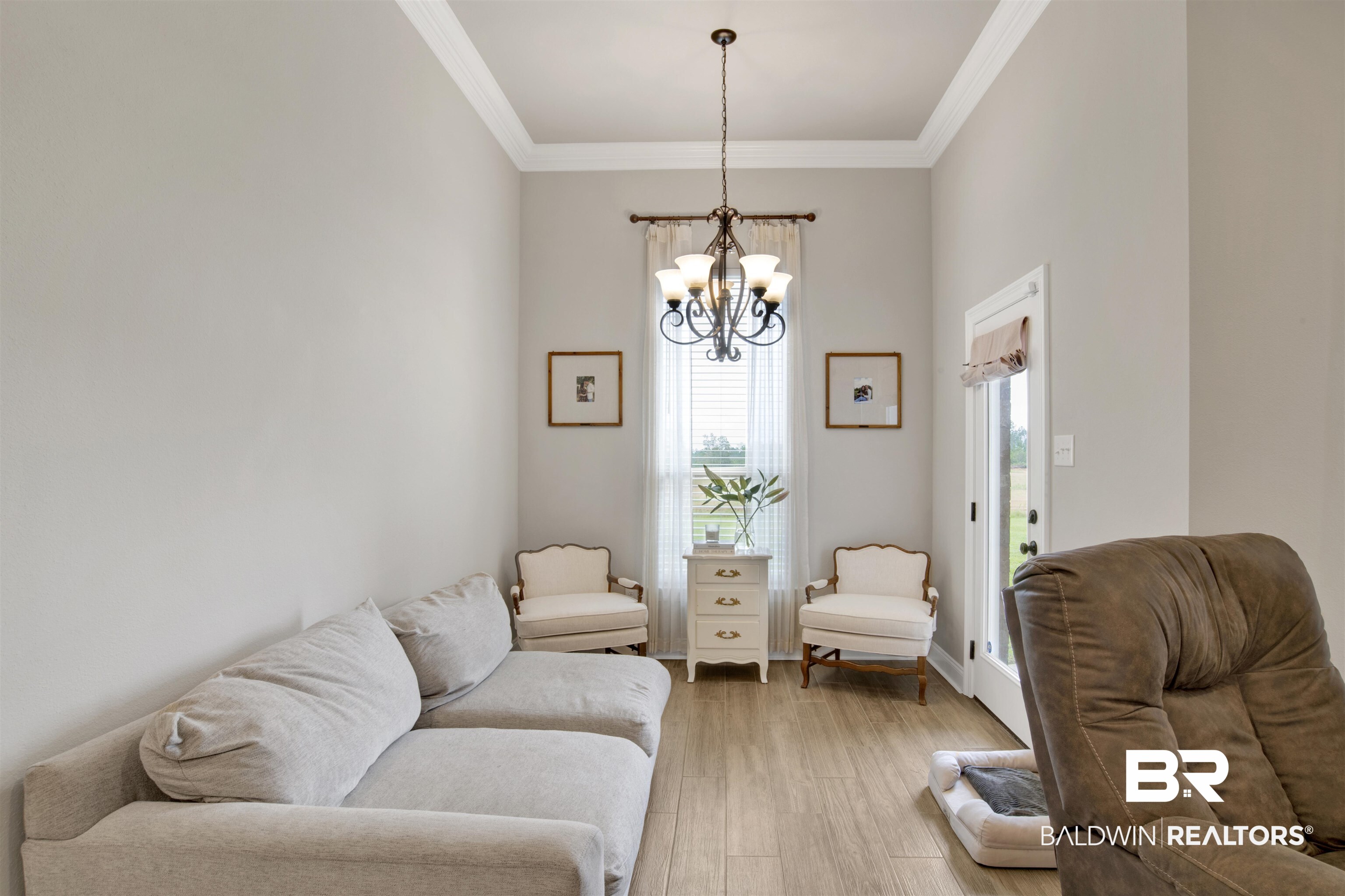 30770 Marcel Boulevard Spanish Fort, AL 36527 - Photo 10 of 23 Living room featuring a chandelier, light hardwood / wood-style floors, and crown molding