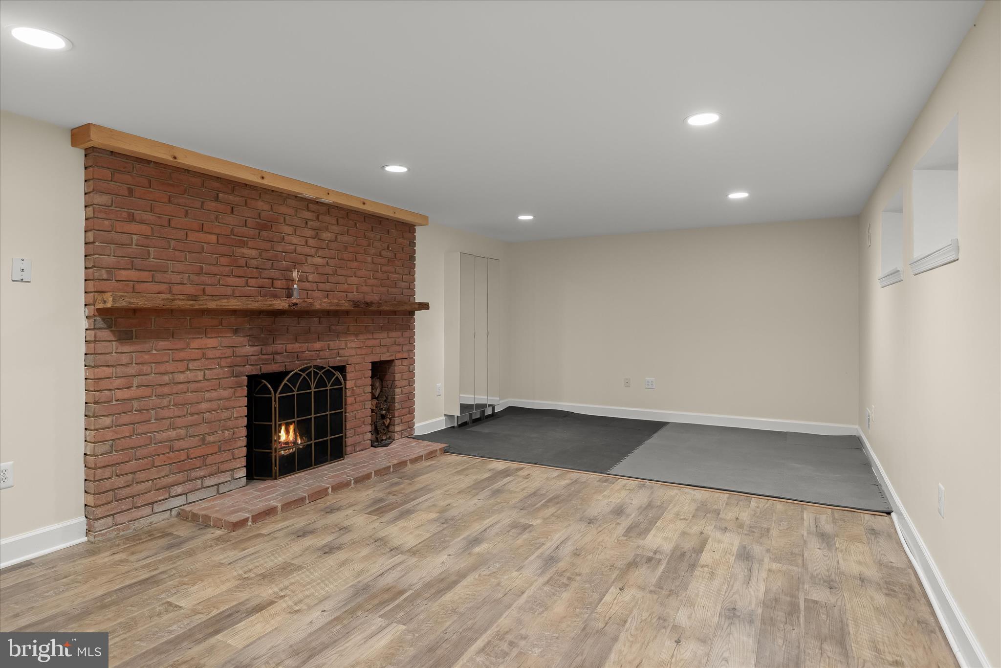 5104 Scarsdale Road Bethesda, MD 20816 - Photo 52 of 68 an empty room with wooden floor and fireplace
