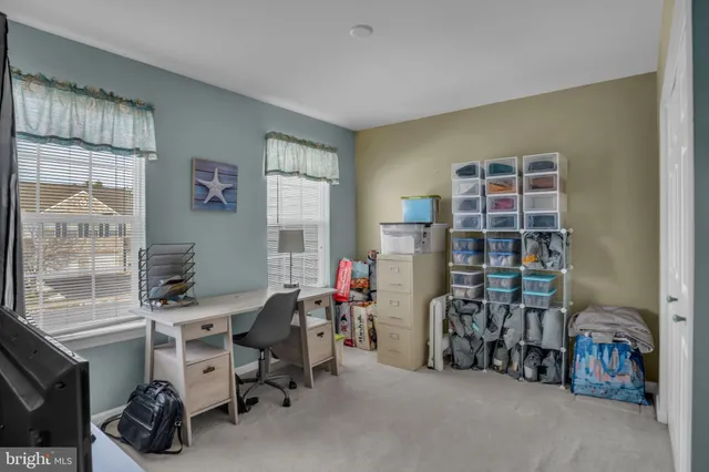 a view of a livingroom with workspace and a window