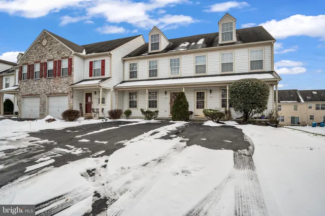 a front view of a residential apartment building with a yard