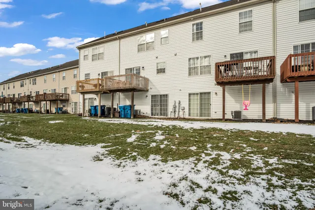 a front view of a building with a yard
