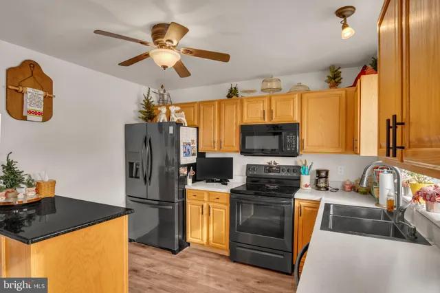a kitchen with stainless steel appliances a stove refrigerator sink and microwave