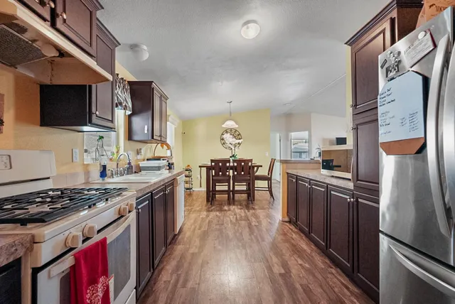 a view of kitchen with cabinets and wooden floor