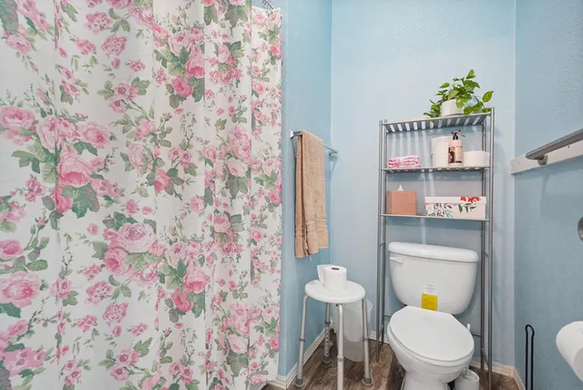 a bedroom with a bed and a dresser in it