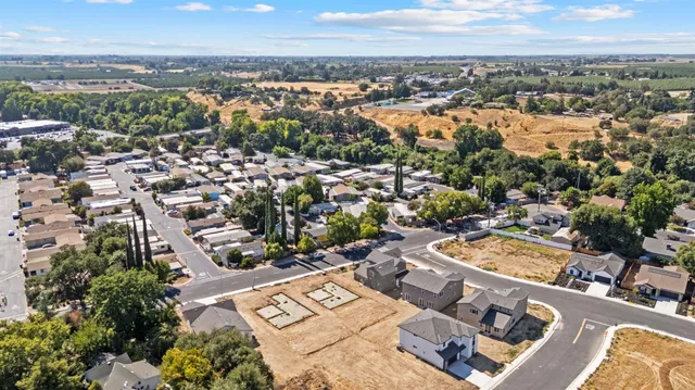 an aerial view of a residential houses with city view
