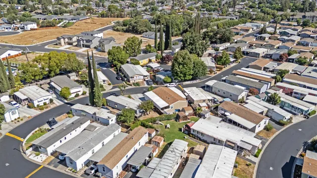 an aerial view of a house with wooden floor and outdoor space