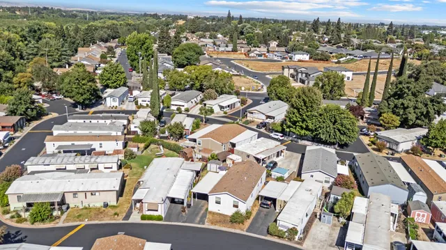a aerial view of a house with swimming pool next to a yard