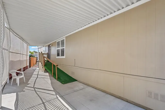 a view of a patio with couches table and chairs and potted plants