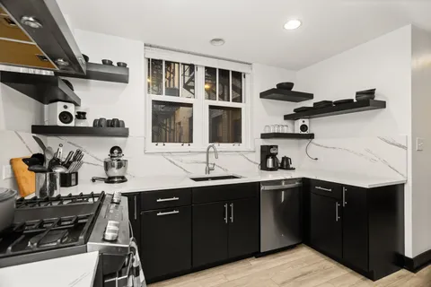 a kitchen with a sink appliances and cabinets