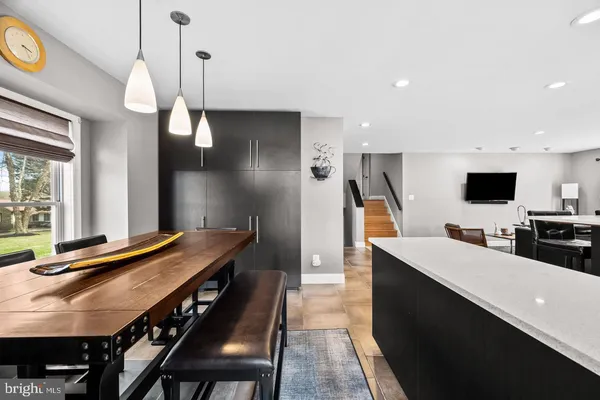 a large kitchen with a table and chairs