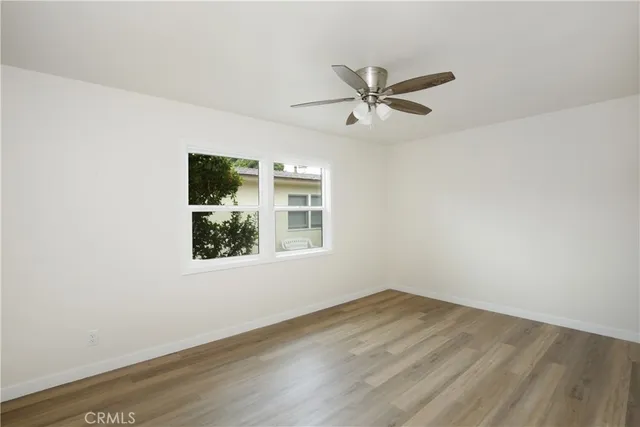 a view of a big room with wooden floor closet and windows
