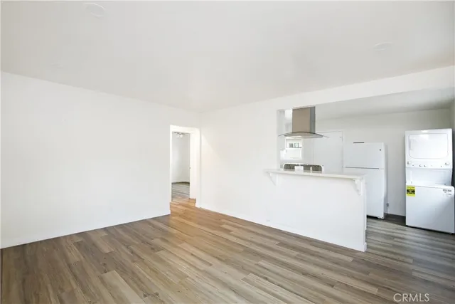 a kitchen with a stove a refrigerator and a white cabinets