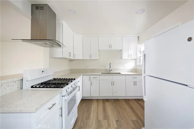 a kitchen with cabinets appliances and a sink