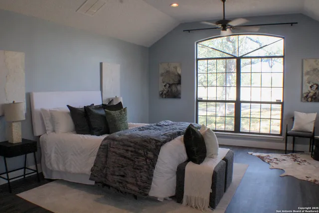 a bedroom with bed and a window