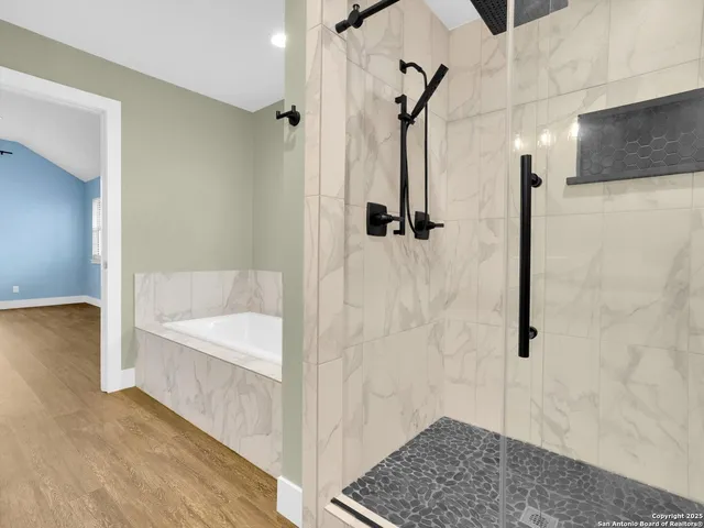 a bathroom with a bathtub and a shower