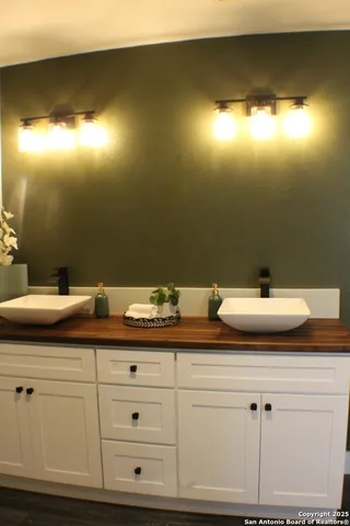 a bathroom with a sink and mirror