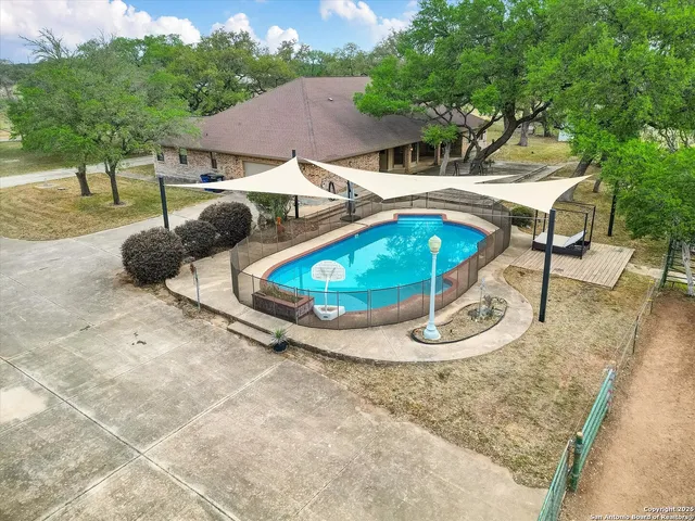 an aerial view of a house with swimming pool