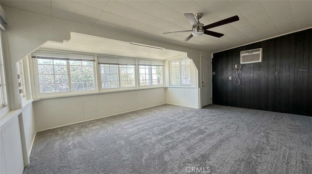 27077 El Rancho Drive Menifee, CA 92586 - Photo 9 of 11 an empty room with chandelier fan and windows