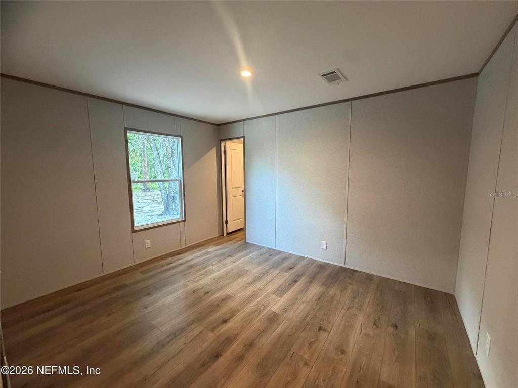 114 Nutmeg Trail Interlachen, FL 32148 - Photo 26 of 33 wooden floor in an empty room with a window
