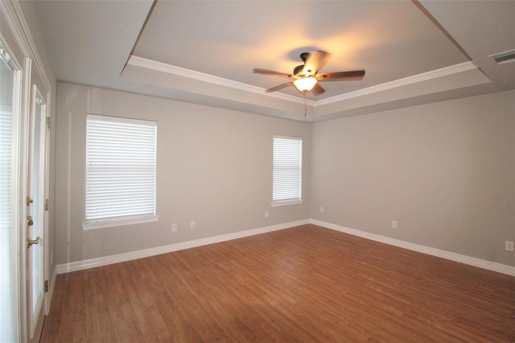 333 Blake Lane Midlothian, TX 76065 - Photo 12 of 25 an empty room with wooden floor chandelier fan and windows