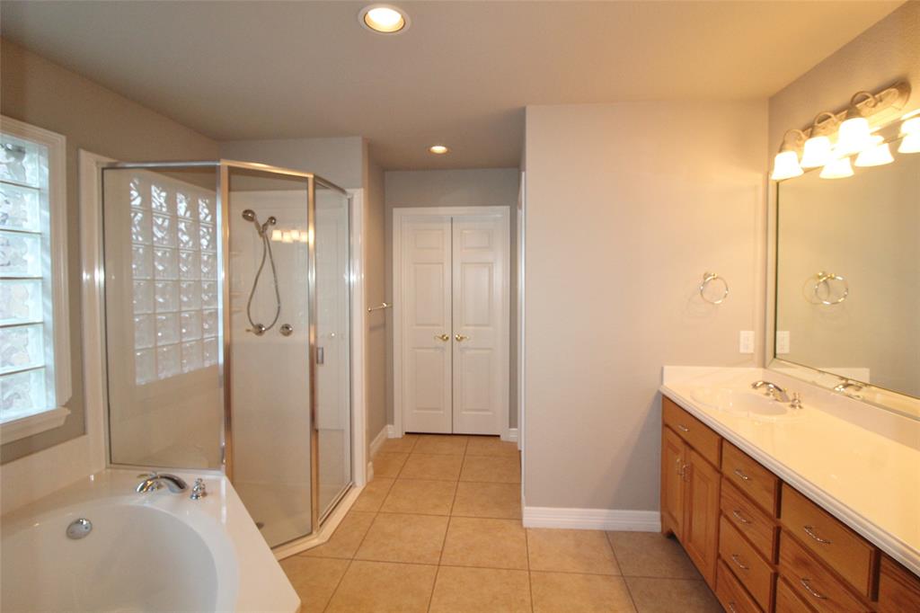 333 Blake Lane Midlothian, TX 76065 - Photo 14 of 25 a bathroom with a tub sink shower and a mirror