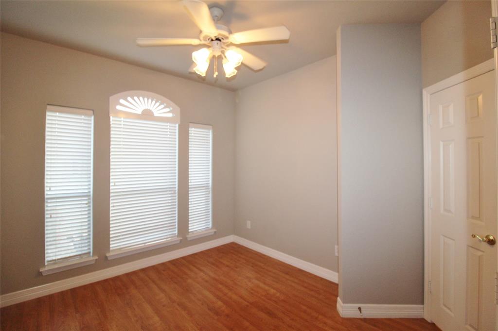 333 Blake Lane Midlothian, TX 76065 - Photo 17 of 25 an empty room with wooden floor fan and windows