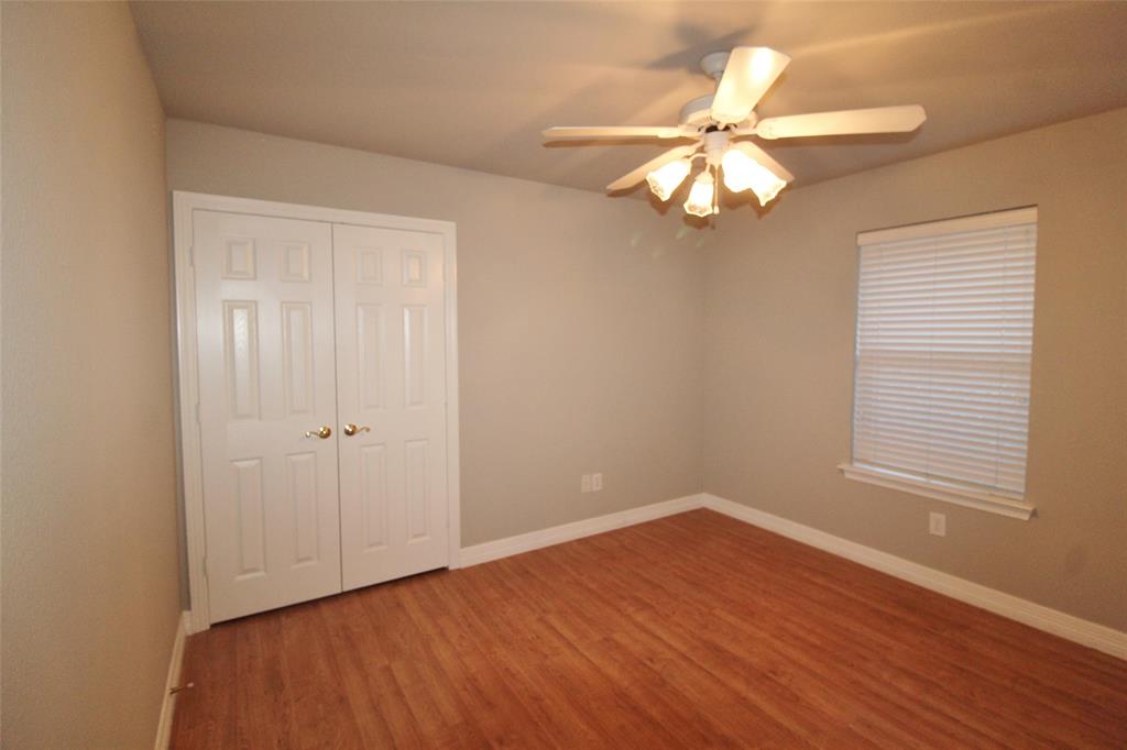 333 Blake Lane Midlothian, TX 76065 - Photo 18 of 25 a view of an empty room with wooden floor and a window