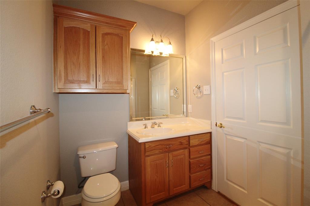 333 Blake Lane Midlothian, TX 76065 - Photo 19 of 25 a bathroom with a sink a toilet and mirror