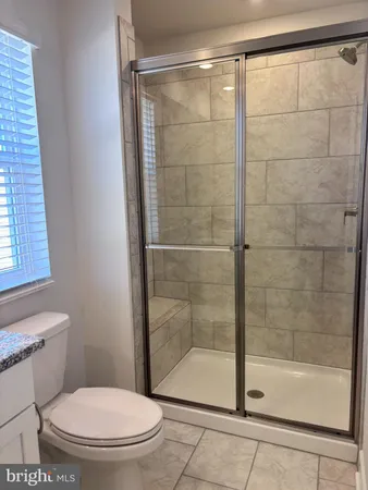 a bathroom with a shower and a toilet