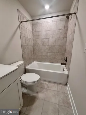 a bathroom with a toilet and a bathtub