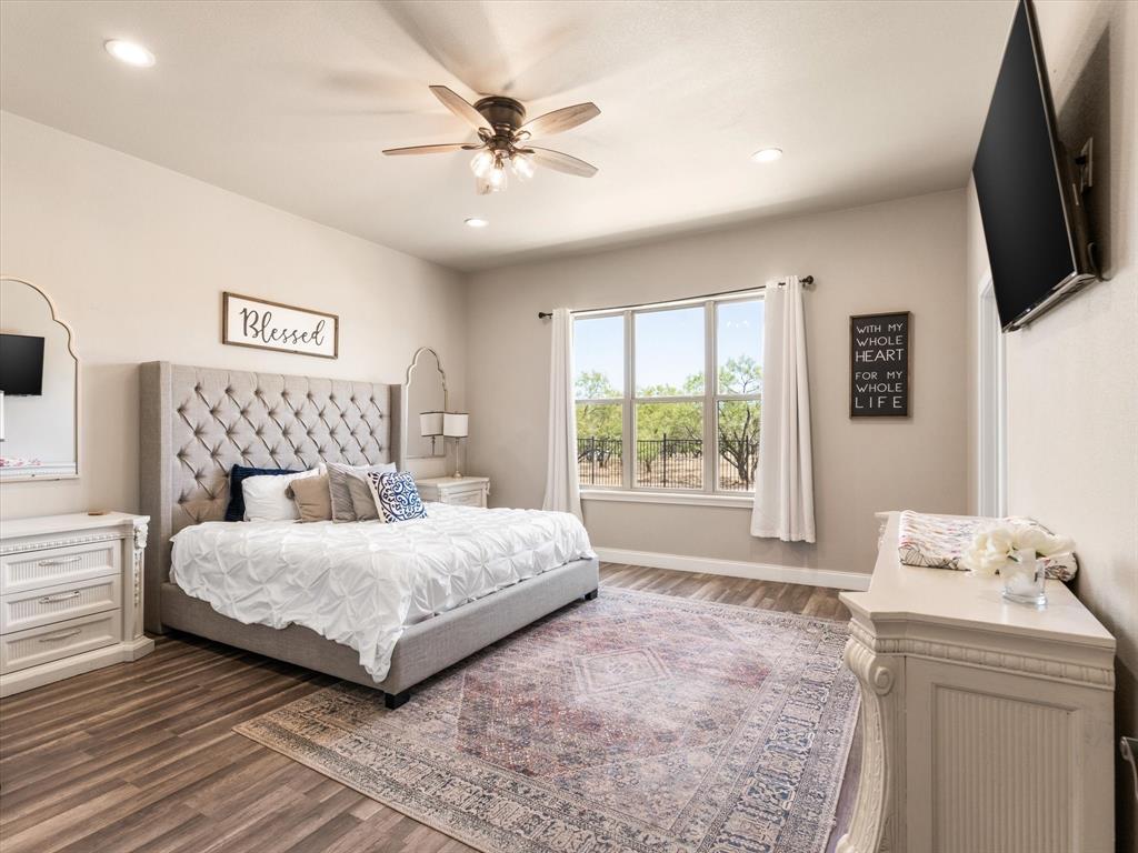 101 Trail Ridge Weatherford, TX 76087 - Photo 16 of 39 a bedroom with a large bed and a flat screen tv