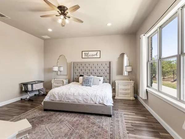 a bedroom with a large bed and a chandelier