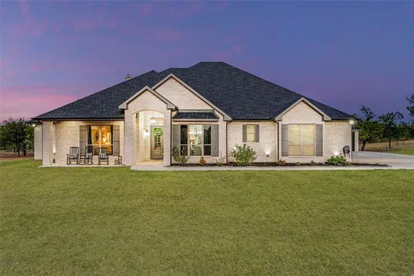 a front view of a house with a garden and porch